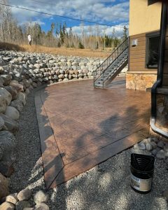 Custom red colored stamped concrete patio with sealer in silverthorne